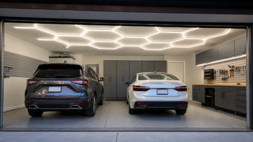 Two-car garage with hexagonal LED tube ceiling lights and linear workbench lighting