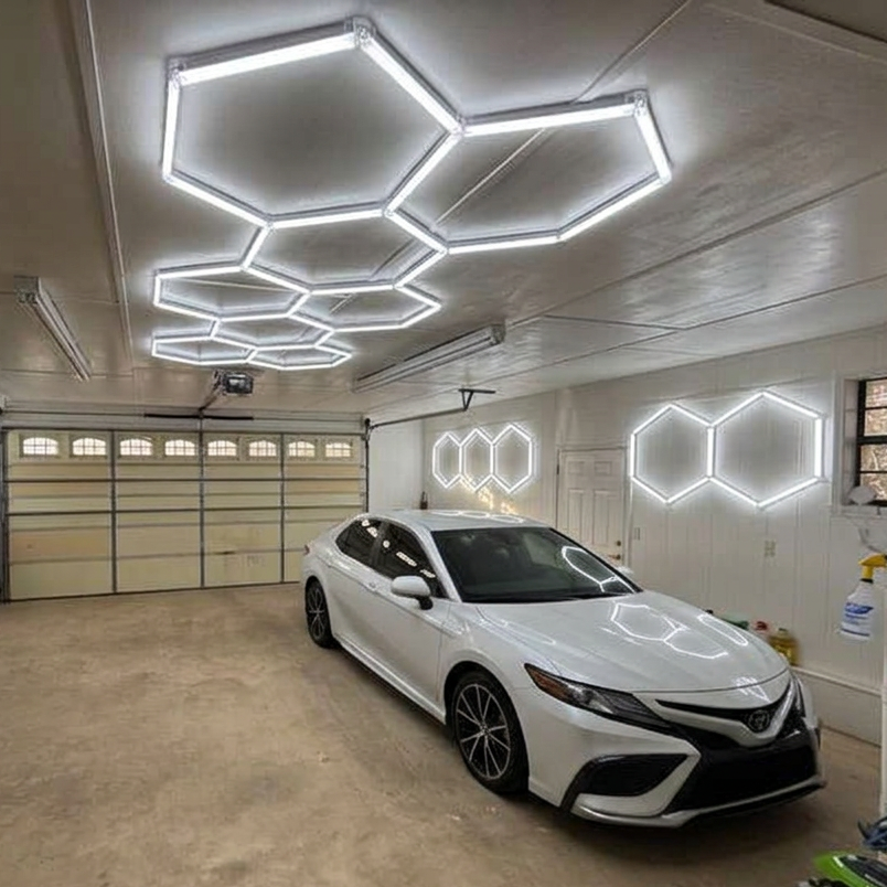 Garage with a white car, neon hexagonal lights on the ceiling and walls, and various items including toys and furniture.