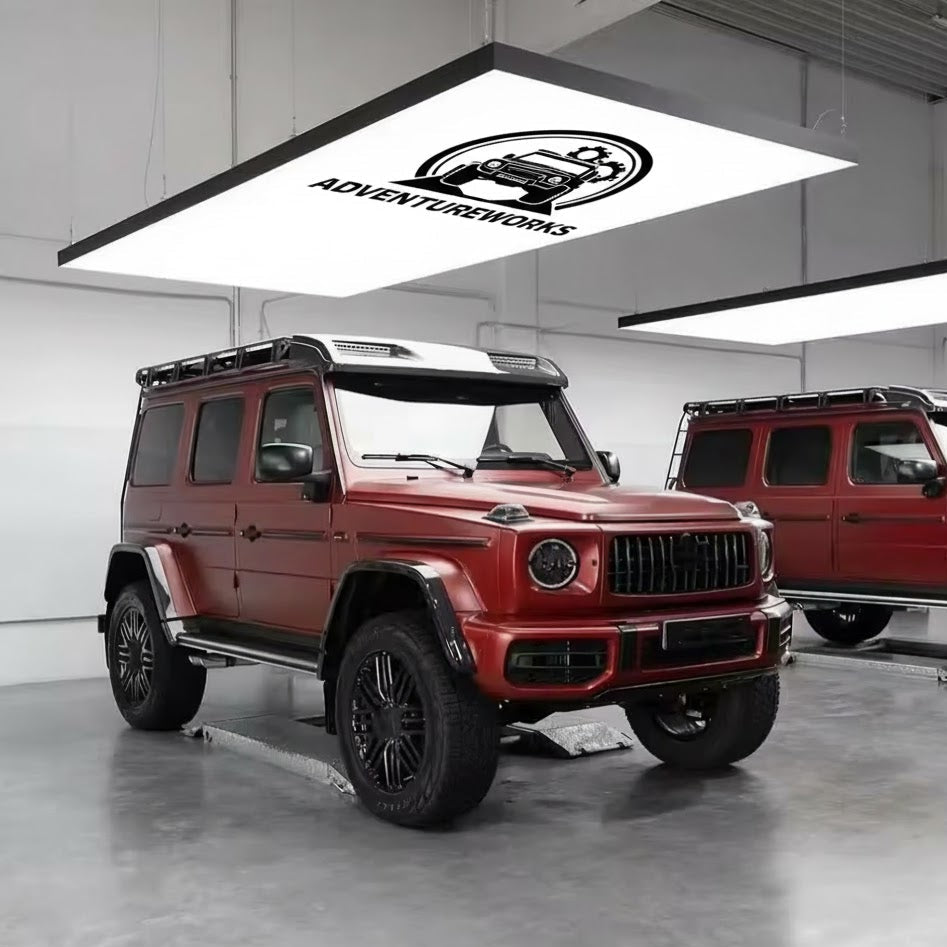 Red off-road vehicle in a showroom with 'Adventuresworks' logo.