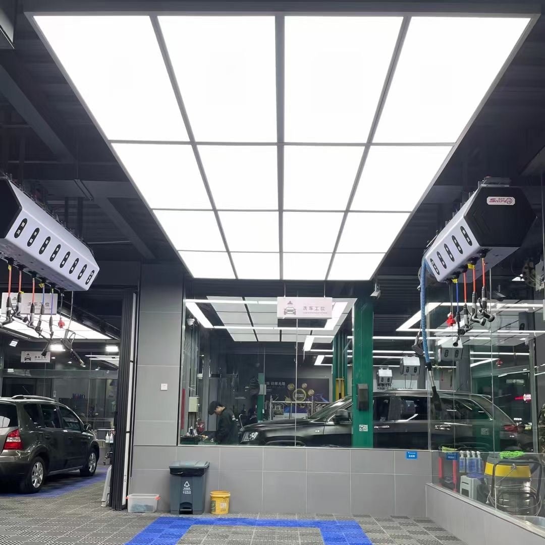 Automotive repair shop interior with cars and equipment.