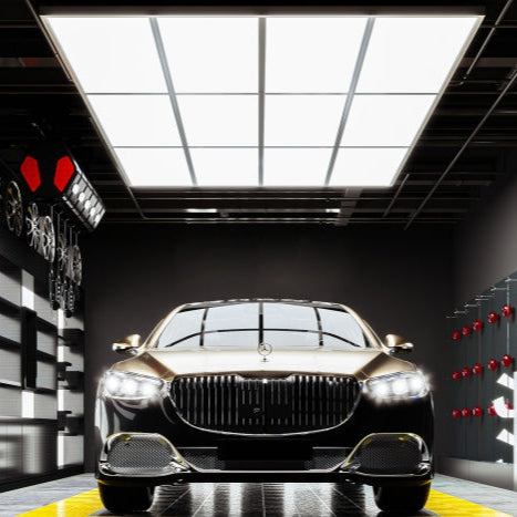 Luxury car in a showroom with checkered floor and digital displays.