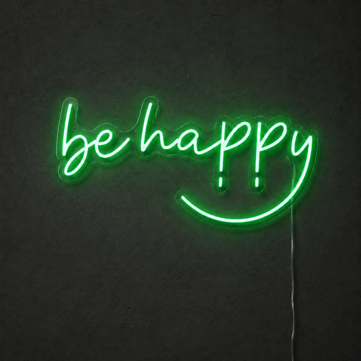 Green Be Happy LED neon sign on a dark charcoal wall