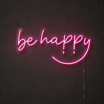 Pink Be Happy LED neon sign on a dark charcoal wall