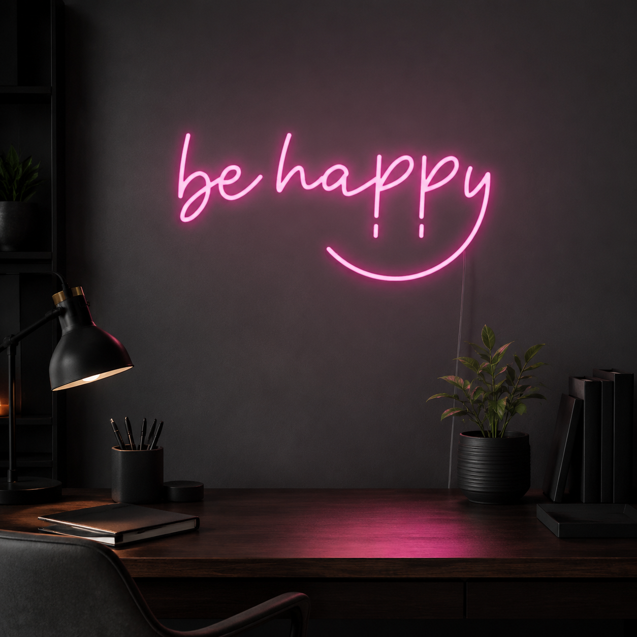Pink Be Happy LED neon sign above a dark home office desk